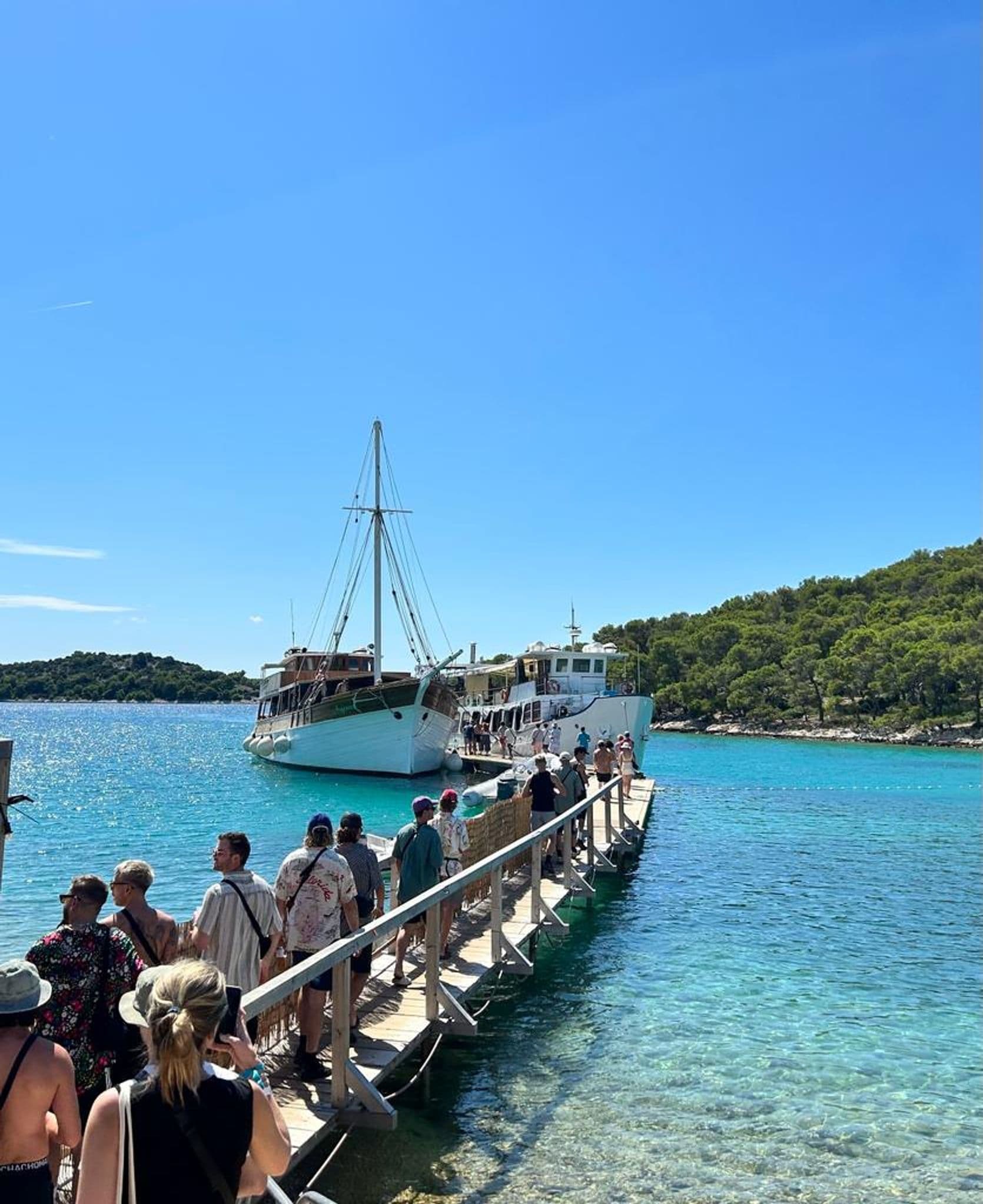 A group lines up to board a yacht