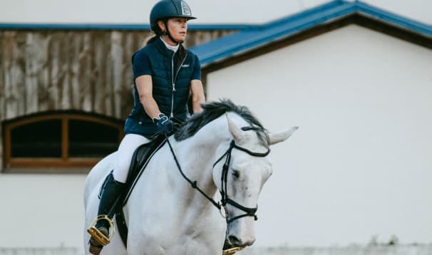 a woman rides a horse