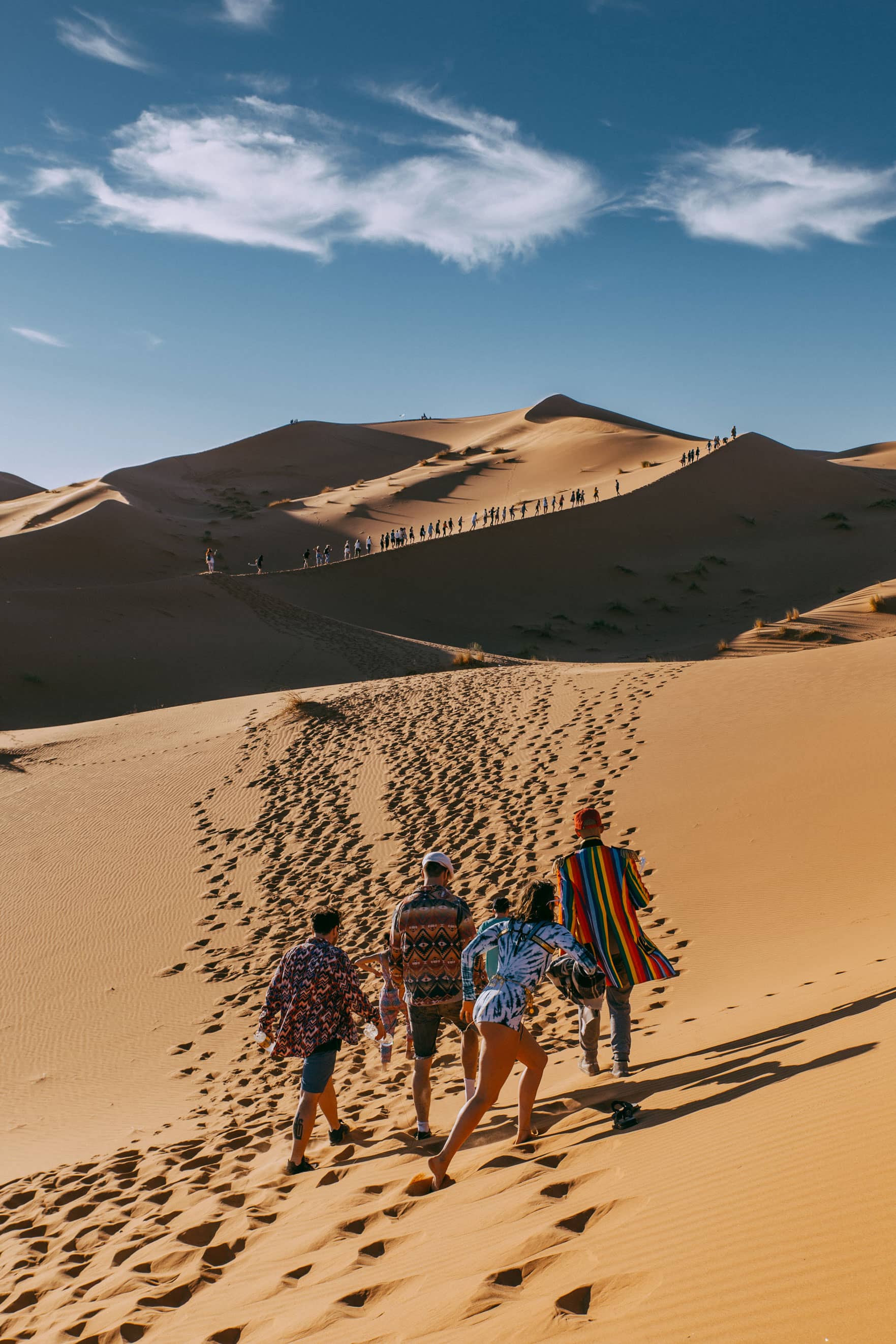 A group climbing a sand dune