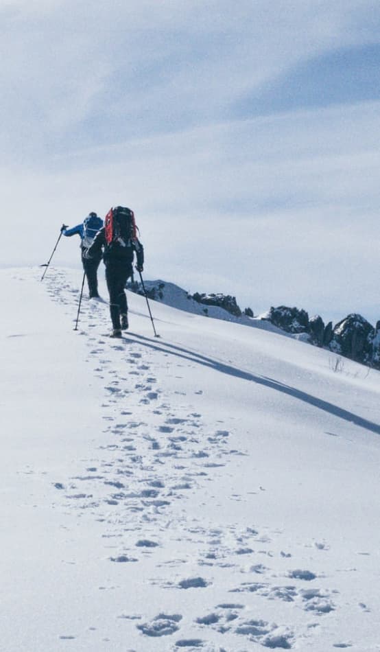 Two hikers on a snowy mountain