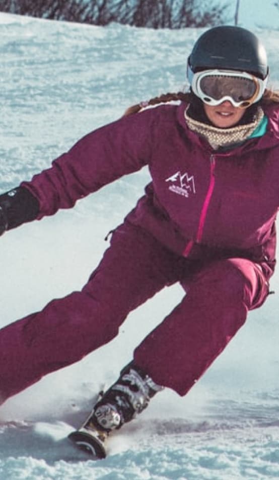 A female skiier racing down a mountain